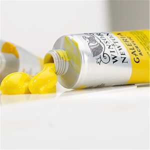 A tube of yellow Galeria Acrylic paint with the lid off, squeezed